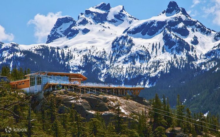 Summit Lodge perched on granite bluffs beneath the snow-covered Tantalus Range