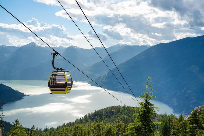 A Sea to Sky Gondola cabin ascending above Howe Sound with the coastal mountains behind